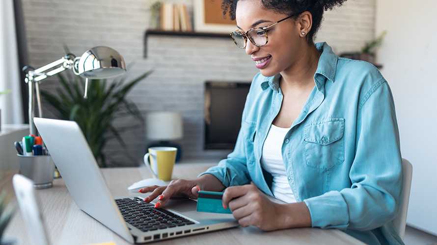 pretty young woman shopping online with credit card